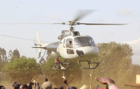 Unidentified Meru man hanging on a chopper ferrying CS Peter Munya on Wednesday June 22, 2022