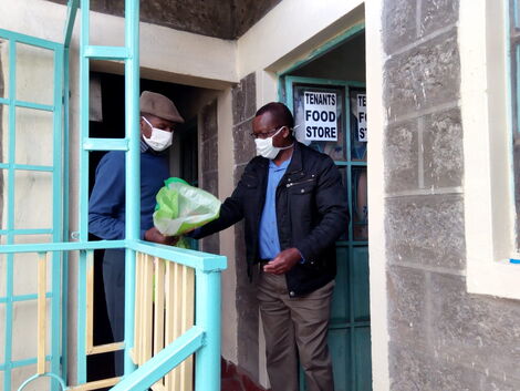 Michael Munene donating foodstuffs to his tenant
