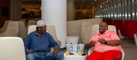 Outspoken lawyer Miguna Miguna (left) speaks to Frankline Mondo Mugisha at the Dubai International Airport - hours before their flight to Nairobi on Wednesday, October 20, 2022.