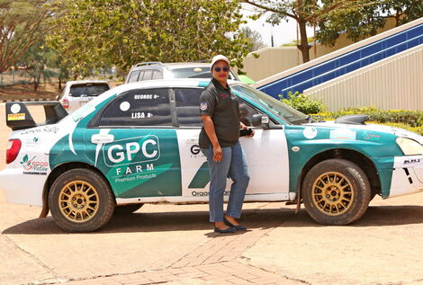 Milka Faith Nyambura posing alongside her car she will use in Safari Rally competition slated for Sunday March 27, 2022 in Nairobi