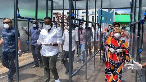 Mombasa Governor Hassan Joho flanked by Mombasa politicians Suleiman Shabhal and Mishi Mboko as they inspect a public spray booth at the Likoni Channel.