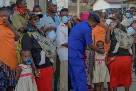 Mombasa Police Commander Rashid Yakub hands a woman and her daughter face masks as they wait for the ferry to arrive in Likoni on Monday, March 31, 2020.
