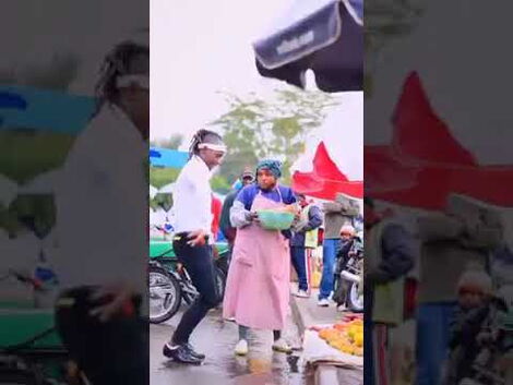 File photo of street artist David Moya surprising a woman in a market 