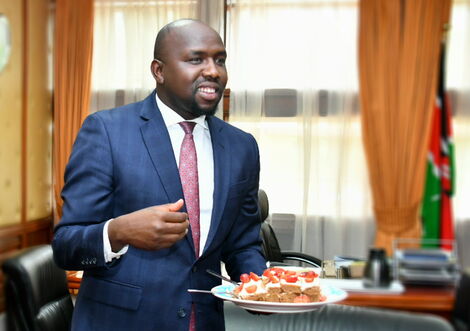 A photo of the Senate Majority Leader Kipchumba Murkomen with a cake in his office.