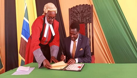 Governor of Tharaka Nithi County Muthomi Njuki signing official documents after his Swearing-in-Ceremony in Tharaka Nithi on August 25, 2022