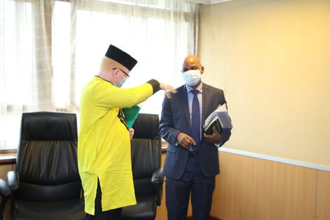 Nominated MP Isaac Mwaura (Left) with Social Protection PS Nelson Marwa on Thursday, May 7.