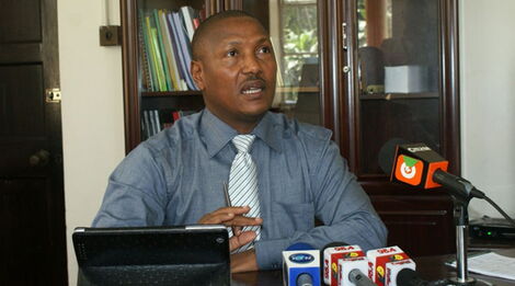 KBC CEO Naim Bilal addressing the press in his office.