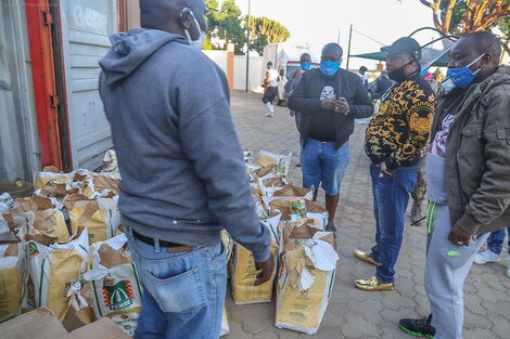 Nairobi Governor Mike Sonko (Black and gold imprinted top) supervising the distribution of essential items in Mua Hills, Machakos County, April 11, 2020.