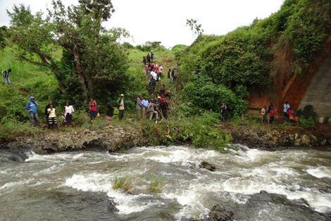 Residents at the banks of River Nyamindi where two bodies were found deda on February 20 2020