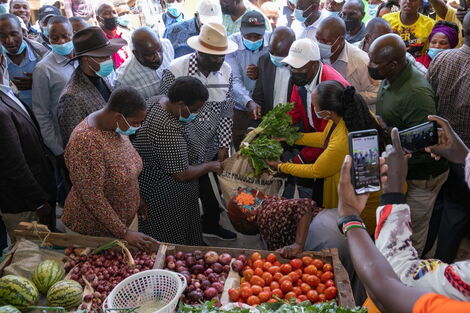ODM leader Raila Odinga purchasing vegetables from a vendor on Monday, September 27.