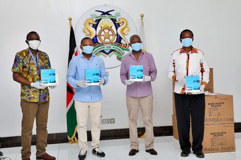 Officials from the Mombasa County Government and representatives of the Kitui County Government pose with masks from the Kitui County Textile Centre (KICOTEC) on April 26, 2020