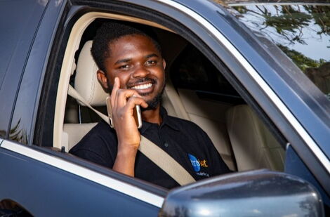 Seth Oluoch poses inside Ultrabet’s Mercedes Benz
