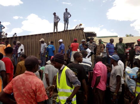 Onlookers at the scene of accident where a truck rammed into buildings in Isiolo