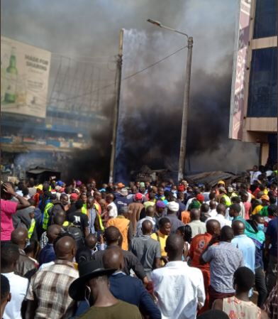 Onlookers at the site where an inferno razed down shops in Kisii on Tuesday, February 15, 2022.