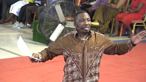 A photo of Pastor James Ng'ang'a of Neno Evangelism delivering a past sermon at the church.