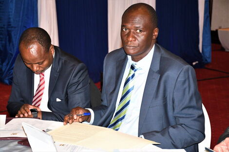 An image of Acting Ministry of Health Director-General Patrick Amoth taking notes at a past meeting.