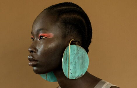 A model showcasing an earring by Ami Doshi
