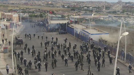 Police officers during the chaos at the Spanish eclave of Melilla