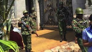 Police officers manning a house.