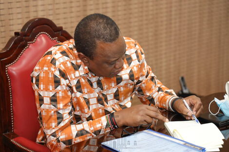 President Uhuru Kenyatta takes notes during the virtual meeting with other African leaders on April 30, 2020.