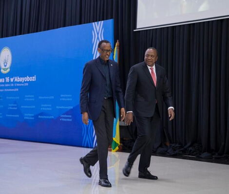 Rwandan President Paul Kagame walks alongside President Uhuru Kenyatta during the Umwiherero Conference in Kigali, Rwanda on March 11, 2019