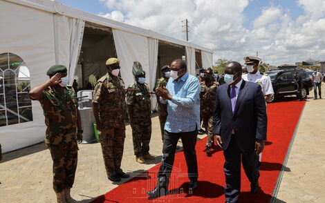 President Uhuru Kenyatta (in blue shirt) and Interior CS Fred Matiang'i (right) arrive at the National Security Industries in Ruiru on Thursday, April 8, 2021