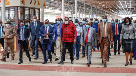 President Uhuru Kenyatta (in red) and other leaders during a tour of Kenya Railways