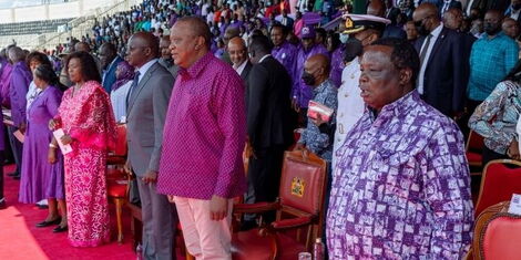 President Uhuru Kenyatta (middle) and COTU Secretary General Francis Atwoli during the Labour Day celebrations at the Nyayo Stadum on May 1, 2022.