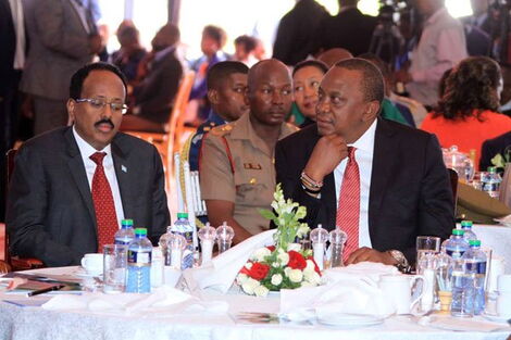 President Uhuru Kenyatta (right) and his Somalia counterpart Mohamed Abdullahi Farmaajo follow proceedings during Kenya's 16th annual National Prayer Breakfast at Safari Park hotel in Nairobi on May 31, 2018.