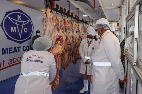 President Uhuru Kenyatta (right) during a tour of Kenya Meat Commission Landhies Deport on Monday, May 24, 2021. 