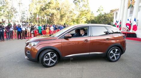 President Uhuru Kenyatta and his French counterpart President Emmanuel Macron inside the brand-new Peugeot 3008 at the Statehouse. March 14, 2019.