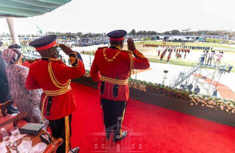 President Uhuru Kenyatta and his bodyguard salute during Jamhuri Day celebrations at Uhuru Gardens on Sunday, December 12, 2021.