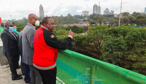 President Uhuru Kenyatta accompanied by Transport CS James Macharia and NMS Director General Mohamed Badi in December 2021.