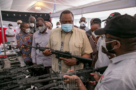 President Uhuru Kenyatta holding the Kenya-made CMZ 4 assault rifle at the KWS Law Enforcement Academy in Manyani, Taita Taveta County, October 16, 2020