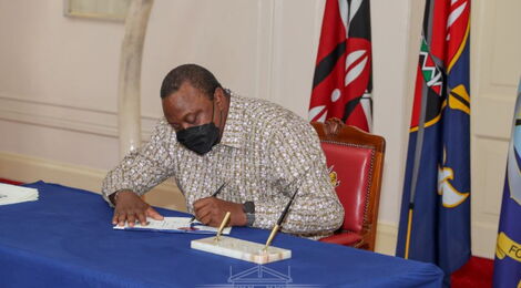 President Uhuru Kenyatta signs the Law of Succession (Amendment) Bill into law at State House on Wednesday, November 17.
