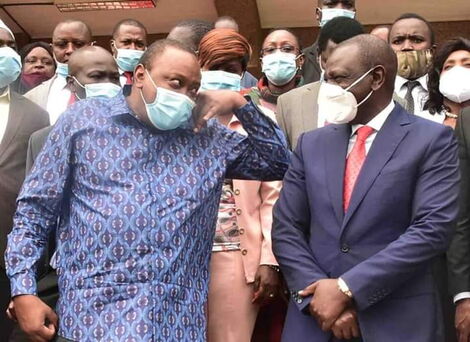 President Uhuru Kenyatta speaks to DP William Ruto outside KICC after PG meeting on Monday, June 22.