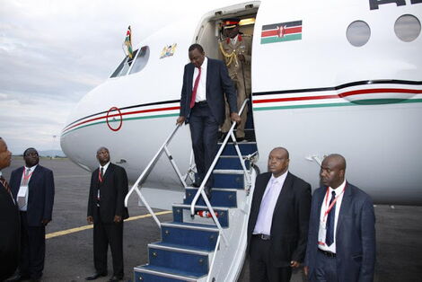President Uhuru Kenyatta stepping out of the Presidential Jet, Fokker 70 ER, alias Harambee One.