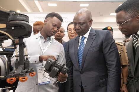 President William Ruto (center) and Sports CS Ababu Namwamba (right) at the Kenya Innovation Week Expo on Tuesday December 6, 2022