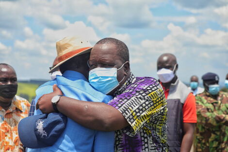 ODM leader Raila Odinga and Interior CS Fred Matiang'i embrace before a fundraiser in Mwongori High School in Kisii County on October 22, 2021.