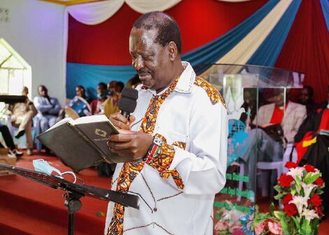 File photo of Former Prime Minister Raila Odinga reading a Bible in Church