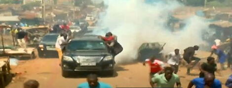 Police officers lob teargas on Azimio la Umoja leader Raila Odinga's convoy in Kawangware, Nairobi on Monday, March 27, 2023.