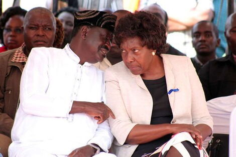 ODM Party leader Raila Odinga whispering to Kitui county governor Charity Ngilu during a past event.