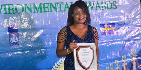 Raquel Muigai poses for a photo with her award during the 2022 African Climate Change and Environmental Reporting (ACCER) Awards.jpg (