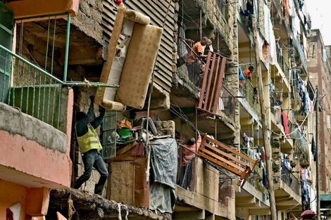Residents move sofas and beds from a block of flats in Nairobi.