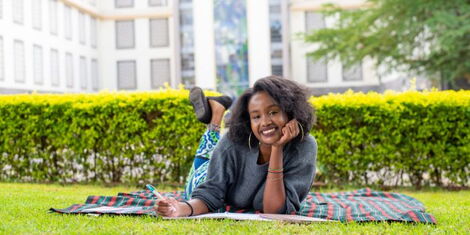 A Riara University student relaxing on the institution's lawn 