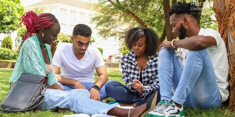 Riara University students study on the institution’s lawn 