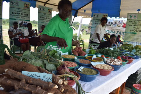 A trader displays her farm produce from Kimira-Oluch irrigation scheme during World Food Day celebrations in Kendu Bay, Homa Bay County on October 16, 2019