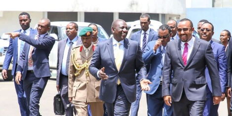 From Left Former Aide De Camp Timothy Lekolool (pointing), new Aide De Camp Fabian Lengusuranga, President William Ruto and Ethiopian Prime Minister Abiy Ahmed on Thursday October 6, 2022