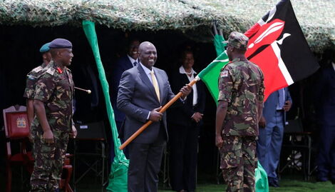 President William Ruto presents the flag to Kenya Defense Forces (KDF) troops during their deployment to the DRC on November 2, 2022.