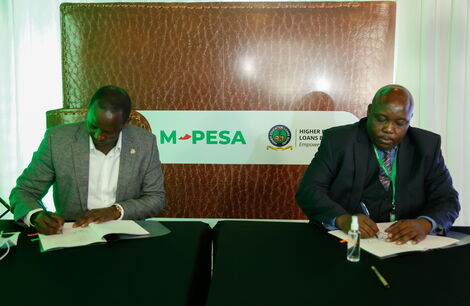 Safaricom Chief Financial Services Officer, Sitoyo Lopokoiyit (left) and HELB CEO Charles Ringera (right) signing a partnership on mobile disbursements under HELB through M-Pesa during its official launch at the CEO’S lounge on March 2, 2021